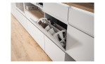 Schuhschrank Shoes mit 1 Schubkasten, 2 Klappen und 1 Tür, in der Farbe Weiß und einem Oberboden in Nox Oak Nachbildung, Detailansicht mit geöffneter Klappe
