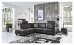 Basis-Ecksofa MONDO Maestra in einem Echtlederbezug in der Farbe Anthrazit. Auf einem dekorierten Hintergrund