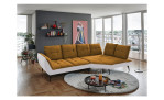 Basis-Ecksofa vito Ticona, in der Farbausführung Mustard / Silber, in einem Raum stehend