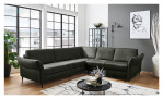 Basis-Ecksofa vito Spring-S Relax in einem grünen Bezugsstoff. Auf einem dekorierten Hintergrund.